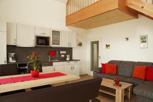 a living room with a couch and a table at Ferienhäuser May in Weigenheim