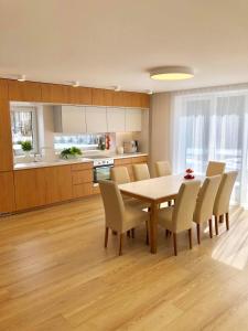 a kitchen and dining room with a table and chairs at Kassari-Nurga Holiday homes in Kassari