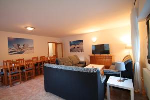 a living room with a couch and a dining room at Pont de Toneta 6,1 Atico Duplex, Ransol, Zona Grandvalira in Ransol