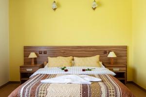 a bedroom with a bed with two towels on it at Hotel Góralski Raj in Nowy Targ +44 photos