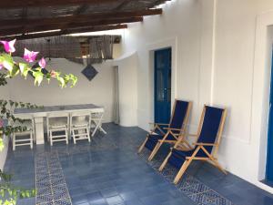 a patio with chairs and a table in a house at Villa in Panarea - Nespolo in Panarea +17 photos