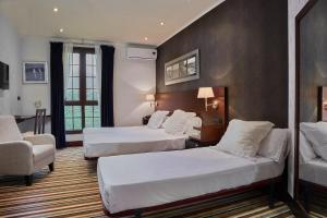 Postel nebo postele na pokoji v ubytování Hotel Granda