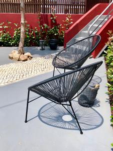 a black metal chair sitting next to a staircase at Confluentia H&A - Believe It or Not Apartments in Coimbra