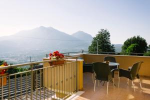 a balcony with a table and chairs and mountains at Villa Amalia in Avellino