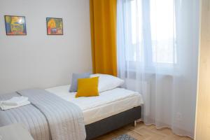 a small bedroom with a bed and a window at Podomek in Kielce