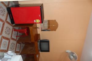 a bathroom with a tv on the wall next to a toilet at Nam Pueng Place 1 in Chiang Saen