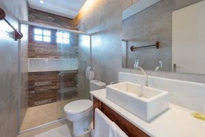 a bathroom with a sink and a toilet and a shower at Pousada Quatro Estações in Porto De Galinhas