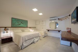 En eller flere senge i et værelse på Pousada Quatro Estações