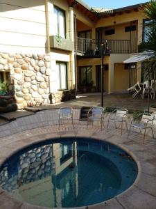 a swimming pool in front of a building at La Magdalena in Mendoza