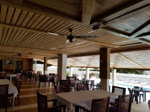 a dining room with tables and chairs and a ceiling at Hotel El Quemaito in Santa Cruz de Barahona
