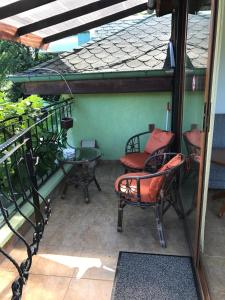 a patio with chairs and a table and a window at Vila Saltanat 41 in Varna City