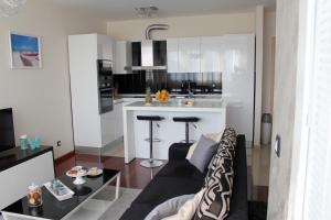 a living room with a couch and a kitchen at Beautiful and luxury apartment in Split centre in Split