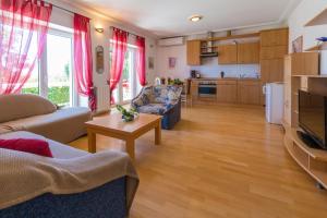 a living room with a couch and a table at Two-Bedroom Apartment in Crikvenica VI in Sopaljska