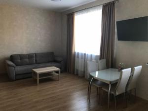a living room with a table and a couch at Apart-hotel Kaut Kompanya in Kimry