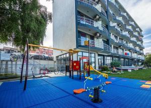 a playground in front of a building at Hotel Vis in Eforie Nord