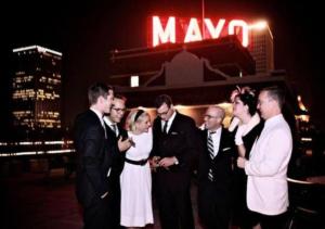 
men and women standing next to each other at The Mayo Hotel in Tulsa
