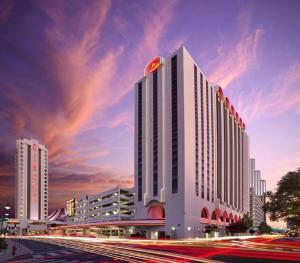 a large white building with a red circle on top of it at Circus Circus Reno Hotel Casino at THE ROW in Reno