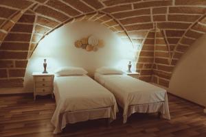 Katil atau katil-katil dalam bilik di La Dimora di Teti