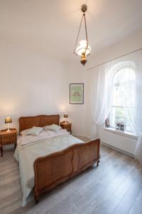 Un dormitorio con una cama grande y una ventana en Apartament Zamkowy en Lądek-Zdrój
