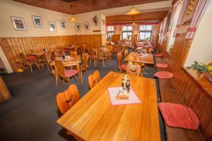 an overhead view of a restaurant with wooden tables and chairs at Penzion Na Rozcestí in Janov nad Nisou