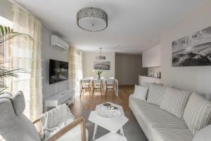 a living room with a couch and a table at "Comfort Stay" - Juodkrante in Juodkrantė