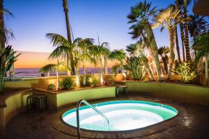 a hot tub with a view of the ocean and palm trees at Pacific Terrace Hotel in San Diego