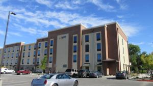 a large building with cars parked in a parking lot at Comfort Inn & Suites Boise Airport in Boise