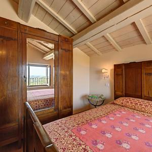 a bedroom with a bed and a large window at Agriturismo Agra Mater in Colmurano