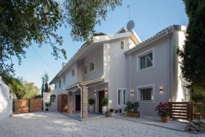 an exterior view of a white house at Gem Villa in Viros Corfu in Virós