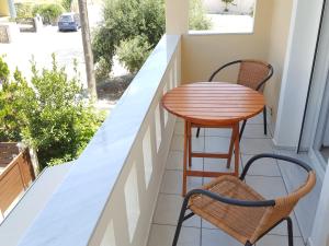 a small table and two chairs on a balcony at Minimalistic Studio Apartments in Heraklio Town