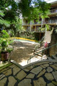 a building with a staircase and a building with a courtyard at Amazing Studio Apartment with Pool - Close to Beach in San Juan del Sur