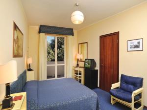 Postel nebo postele na pokoji v ubytování Hotel & Residence Dei Duchi