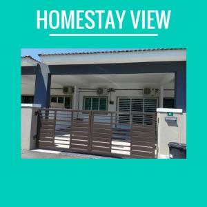 a house with a giveaway sign in front of it at Dais Homestay Ipoh in Ipoh