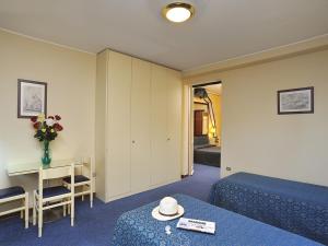 Postel nebo postele na pokoji v ubytování Hotel & Residence Dei Duchi