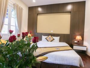 Giường trong phòng chung tại Blubiz Hotel My Dinh Song Da
