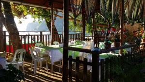 a table and chairs sitting under a pavilion at Telesfora Beach Cottage in El Nido +67 photos
