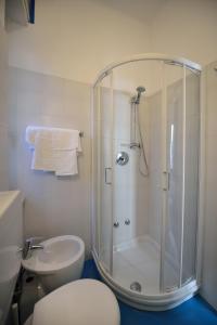 a bathroom with a shower and a toilet and a sink at Hotel Guya in Varazze