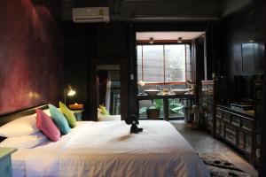 a bedroom with a large bed and a bathroom at Villa Thapae in Chiang Mai
