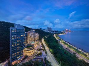 an aerial view of a city and the water at Grand Bay Hotel Zhuhai in Zhuhai