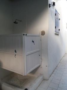 a white cabinet with two doors in a room at Con i piedi nell'acqua in Stromboli