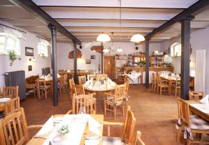 a restaurant with tables and chairs in a room at Altes Stadttor in Kastellaun