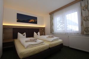 Postel nebo postele na pokoji v ubytování Lärchenheim Apartments