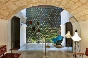 a lobby with a large window and a blue chair at Palazzo Calò in Bari