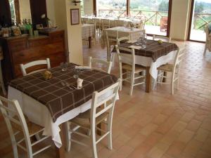 a dining room with tables and chairs in a room at Agriturismo Agra Mater in Colmurano