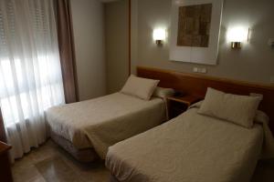 Postel nebo postele na pokoji v ubytování Hotel Escudero