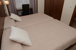 Postel nebo postele na pokoji v ubytování Hotel Escudero