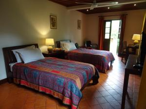 a hotel room with two beds in a room at Villa Maydou Boutique Hotel in Luang Prabang +83 photos