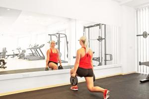 two women in a gym looking in a mirror at Sunprime Protaras Beach - Adults Only in Protaras