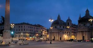 a group of buildings in a city at night at Maison Vantaggio in Rome