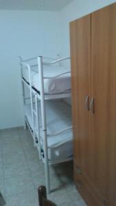 a white bunk bed in a room next to a cabinet at Gaeta, vicino al mare in Gaeta